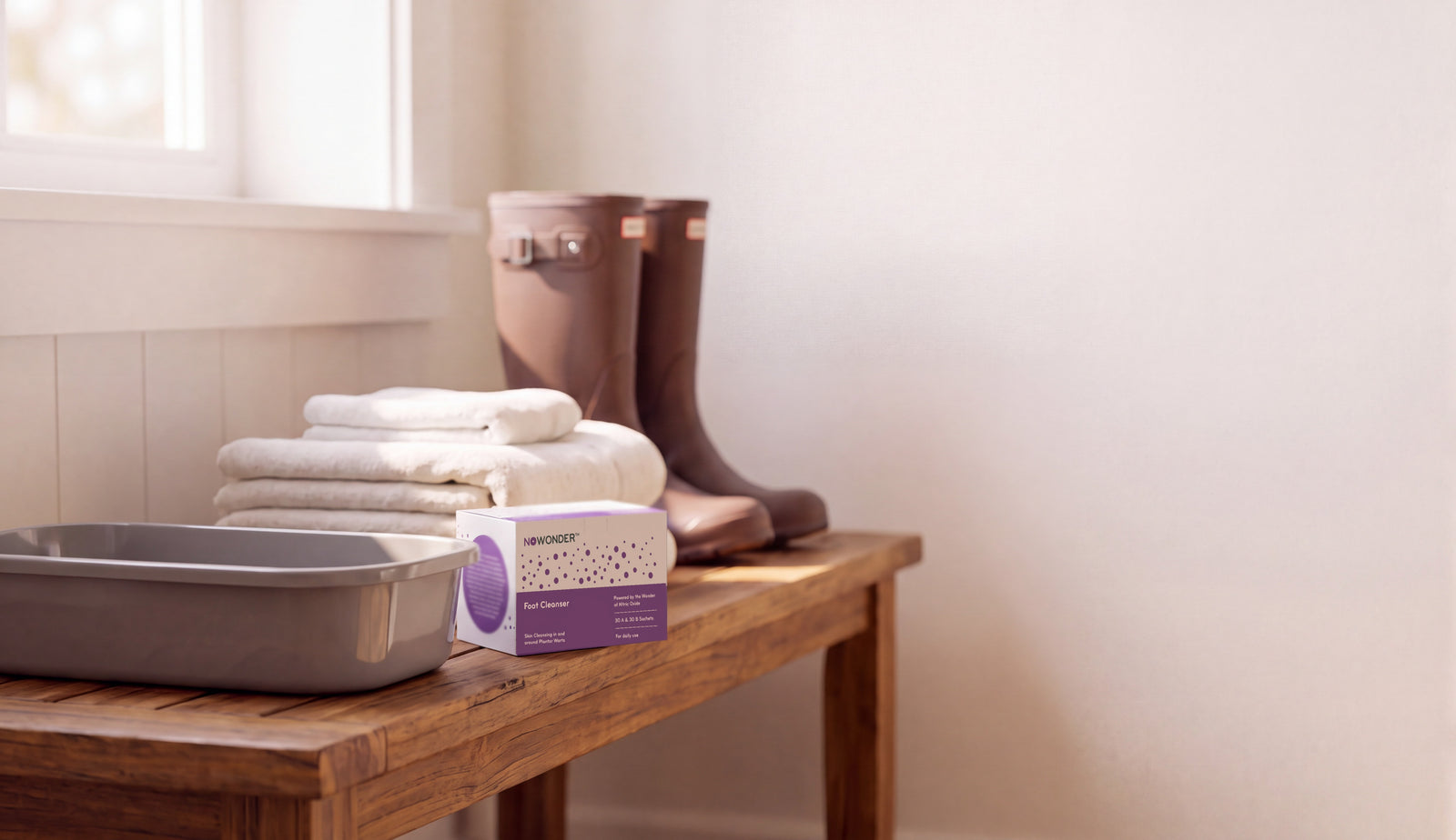 NOWonder Foot Cleanser box beside the soaking basin on a wooden bench