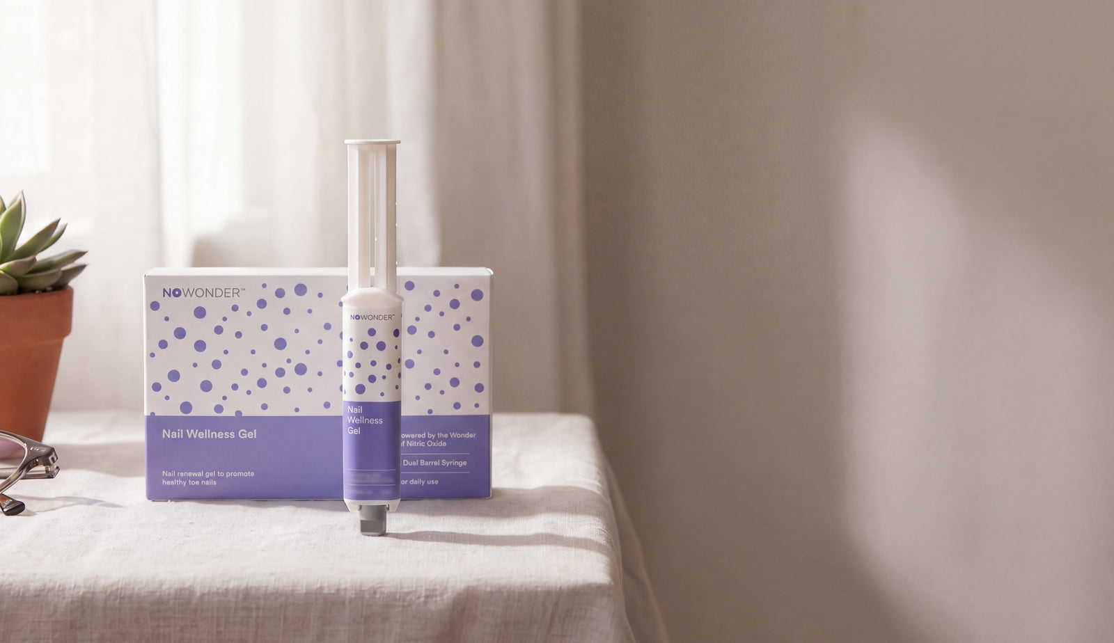 NOWonder Nail Wellness Gel box and syringe on a sunlit linen table