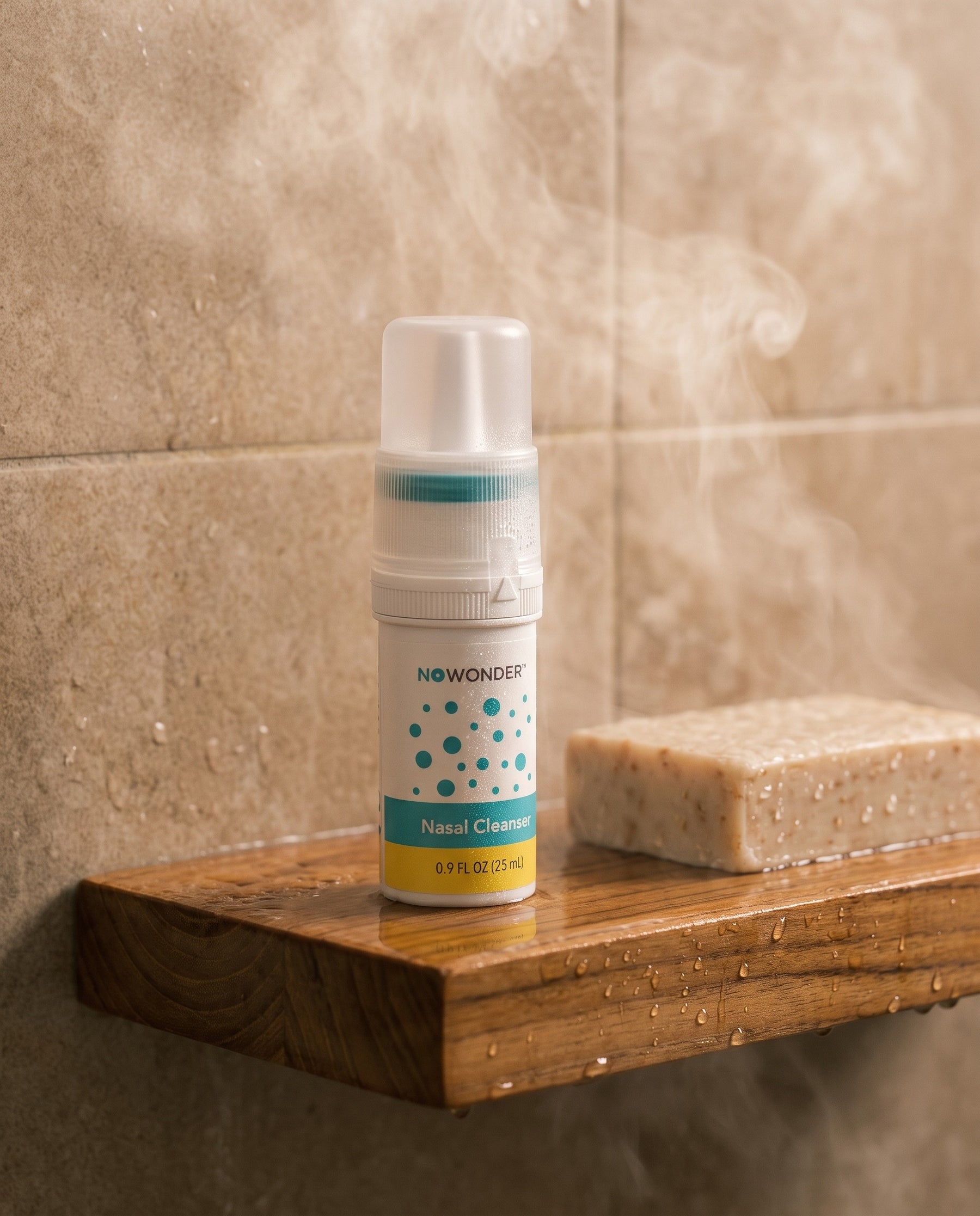 NOWonder bottle with closed cap on teak shower shelf with soap and steam — gallery tile